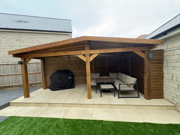 Timber Pergola and Garden Transformation in Weston-Super-Mare Bespoke timber pergola with a covered seating area, porcelain patio and artificial grass in Weston-Super-Mare.